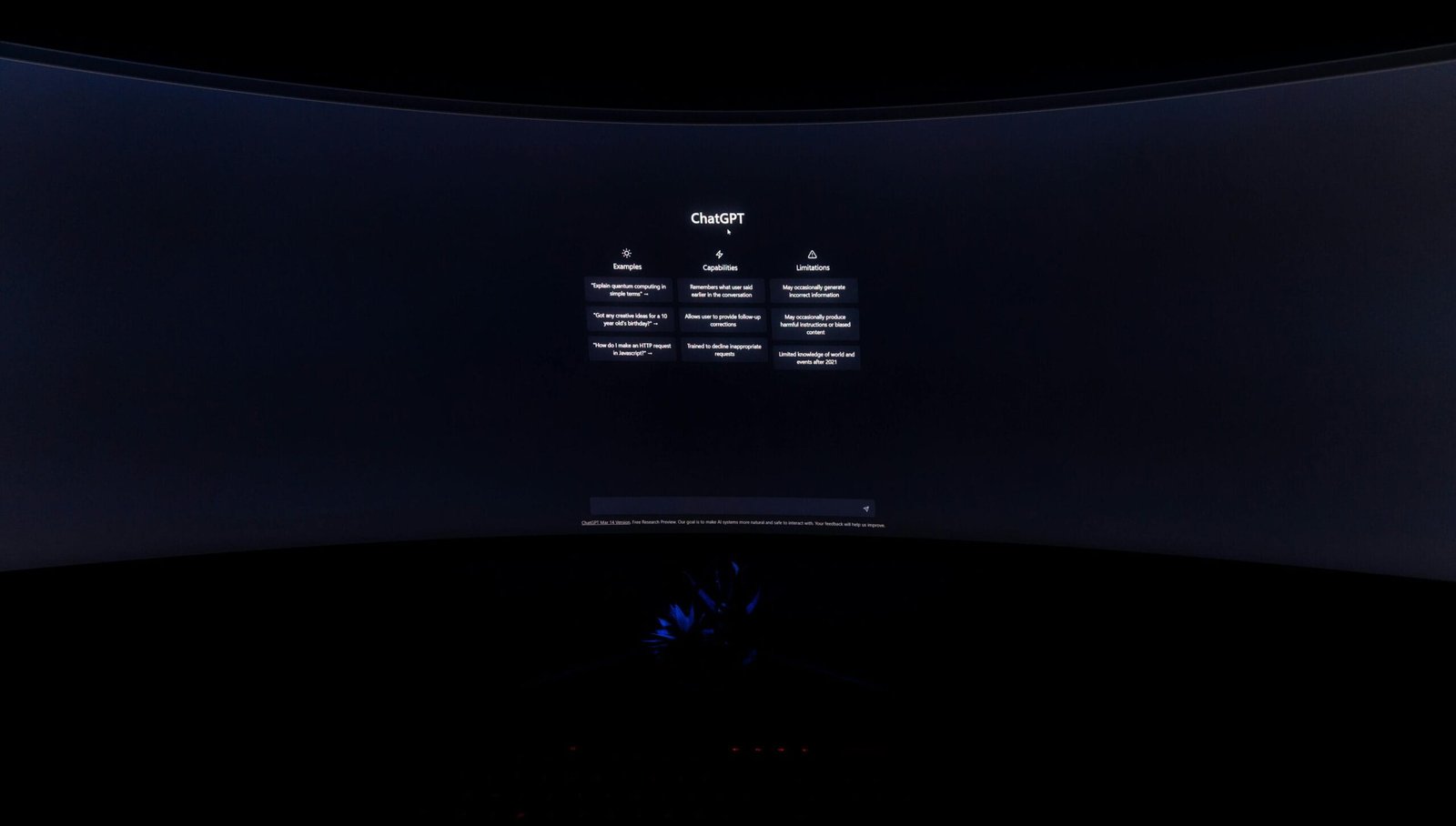 A dimly lit computer screen showing the ChatGPT interface in a dark setting.