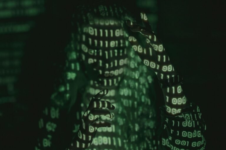 An unrecognizable person with binary code projected, symbolizing cybersecurity and digital coding.